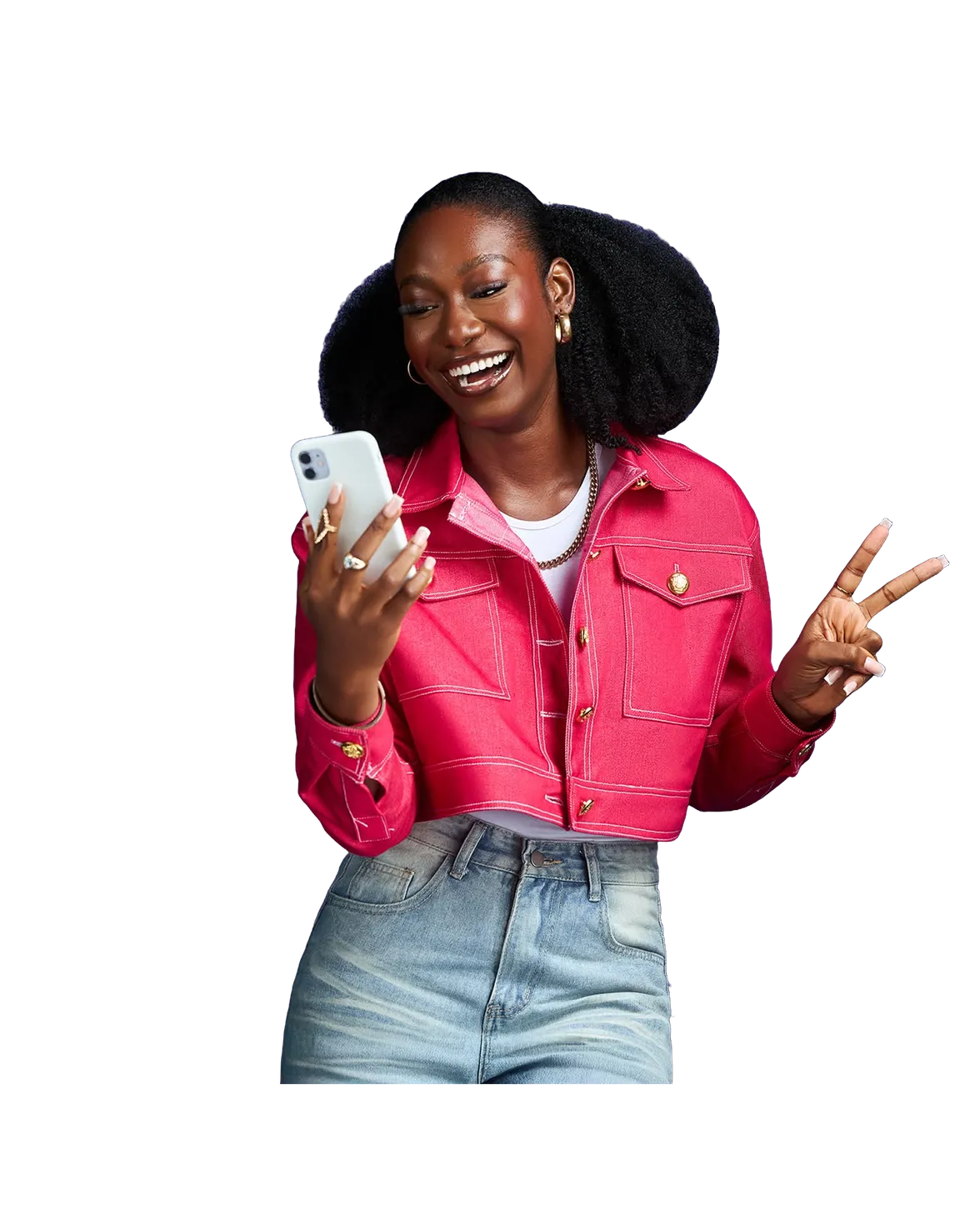 Une femme en veste rose rit devant son téléphone et fait le signe de la victoire.